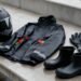 Capacete, capa de chuva, luvas e botas impermeáveis sobre uma bancada